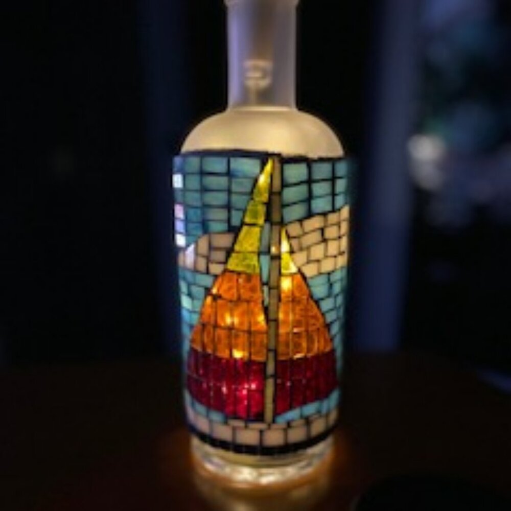 Stained glass mosaic on clear bottle with fairy lights cork.